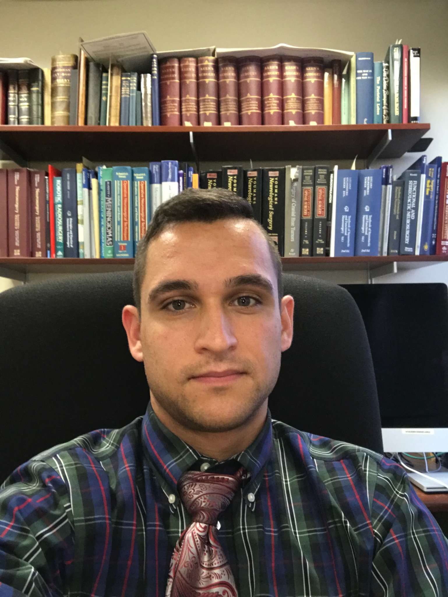 Joseph M. Galante seated in an office with bookshelves